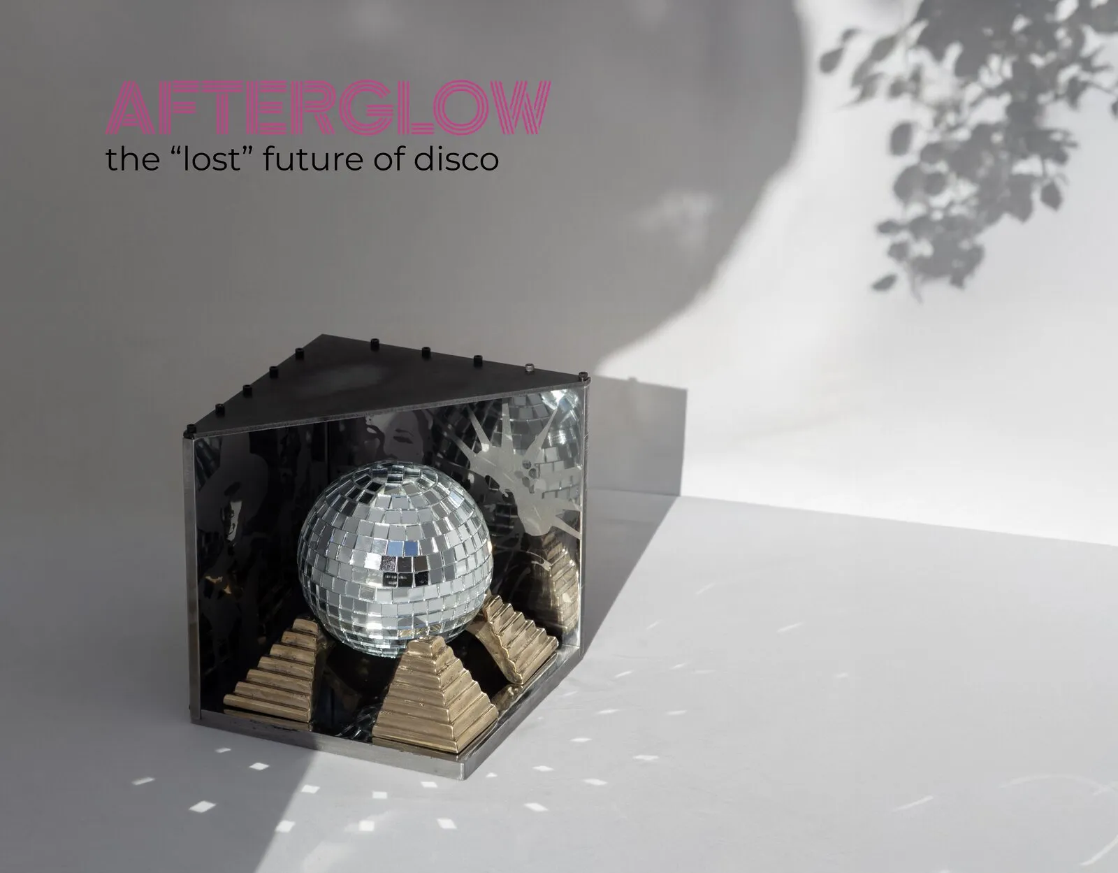 Afterglow — a speculative mirror-ball artifact in a steel-and-resin box