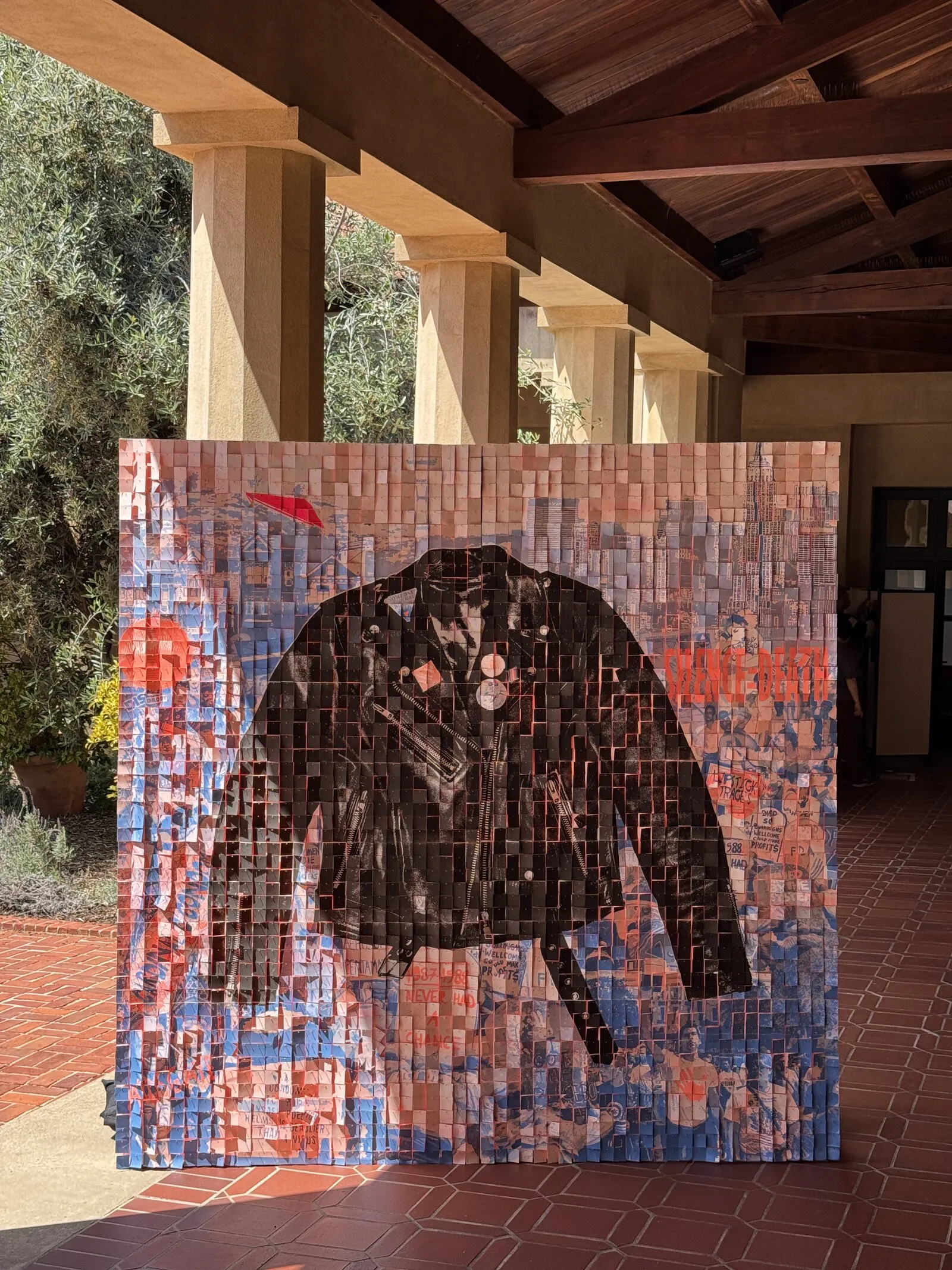 A risograph leather-jacket AIDS-memorial mural, built as a tiled physical artifact