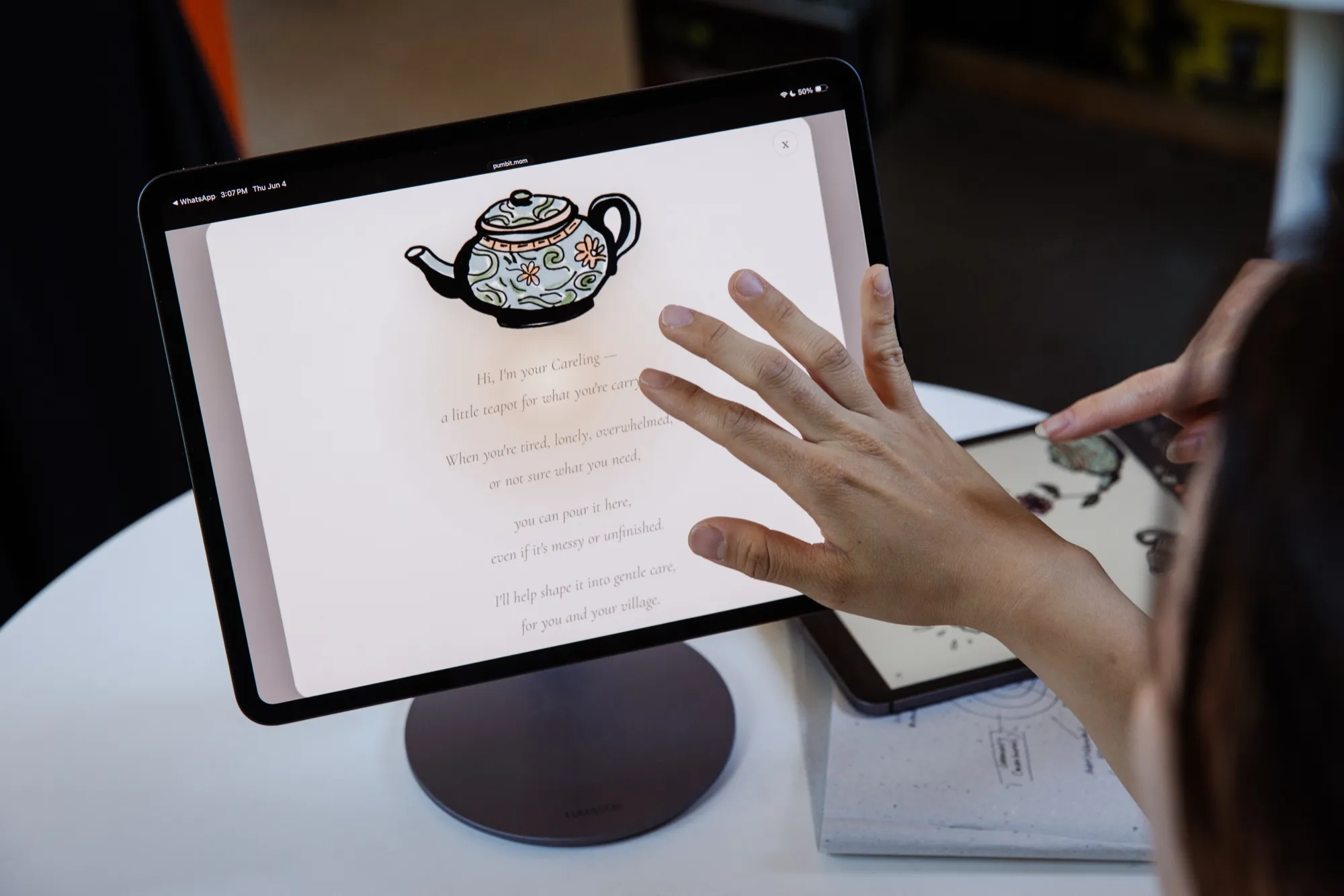 A hand reaching for the tea ceremony — one of Pumbit's hand-drawn gestures of care on the prototype